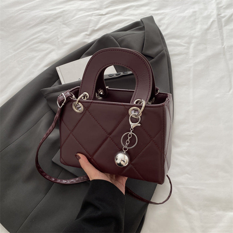 Casual, minimalist, and uniquely designed small square bag.