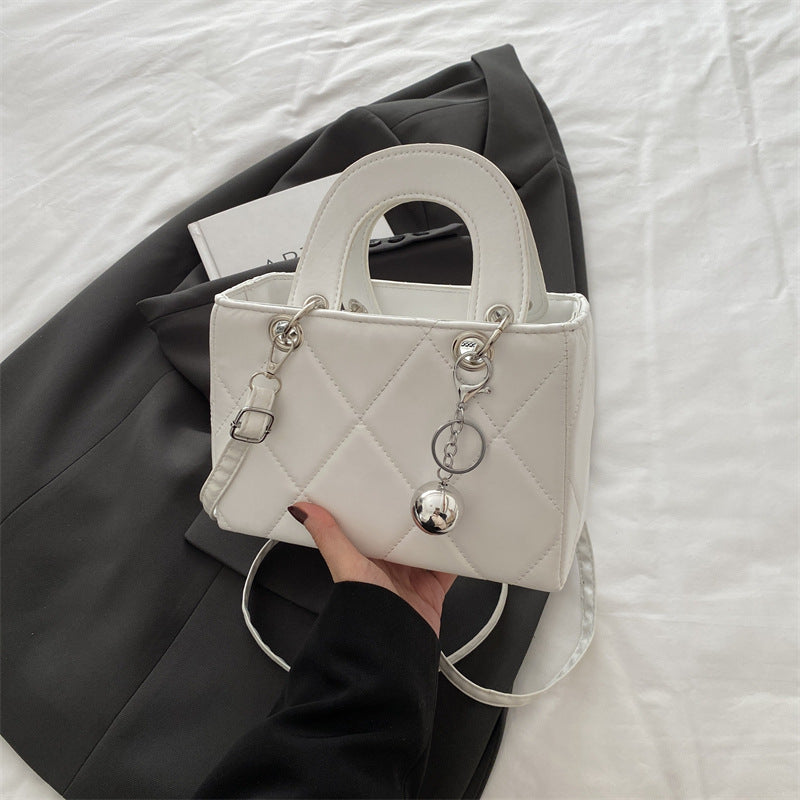 Casual, minimalist, and uniquely designed small square bag.