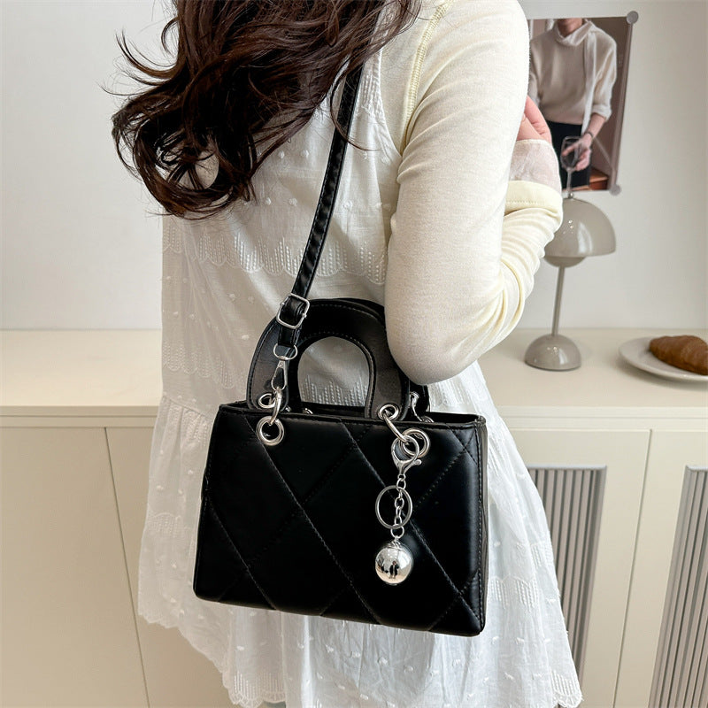 Casual, minimalist, and uniquely designed small square bag.