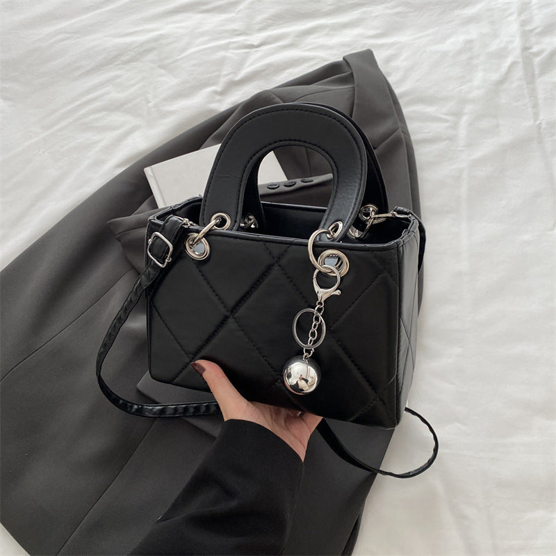 Casual, minimalist, and uniquely designed small square bag.