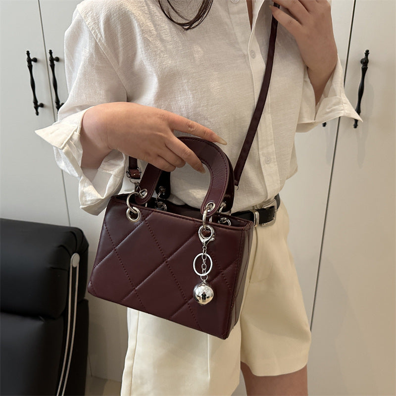Casual, minimalist, and uniquely designed small square bag.